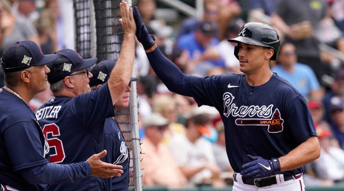 Braves hitting coach Kevin Seitzer, left, gets a high five from first baseman Matt Olson, right, after Olson's solo home run in the first inning during spring training baseball game against the Boston Red Sox at CoolToday Park